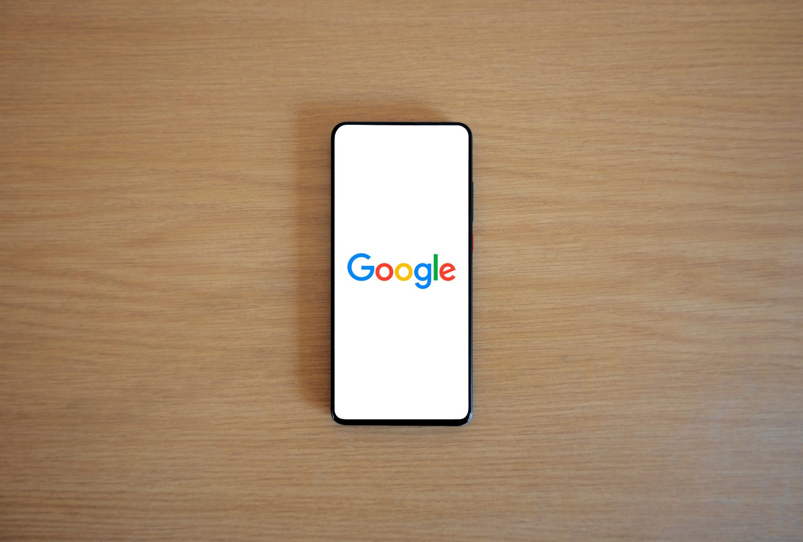 Google search open on a smartphone, representing AI-assisted agent research